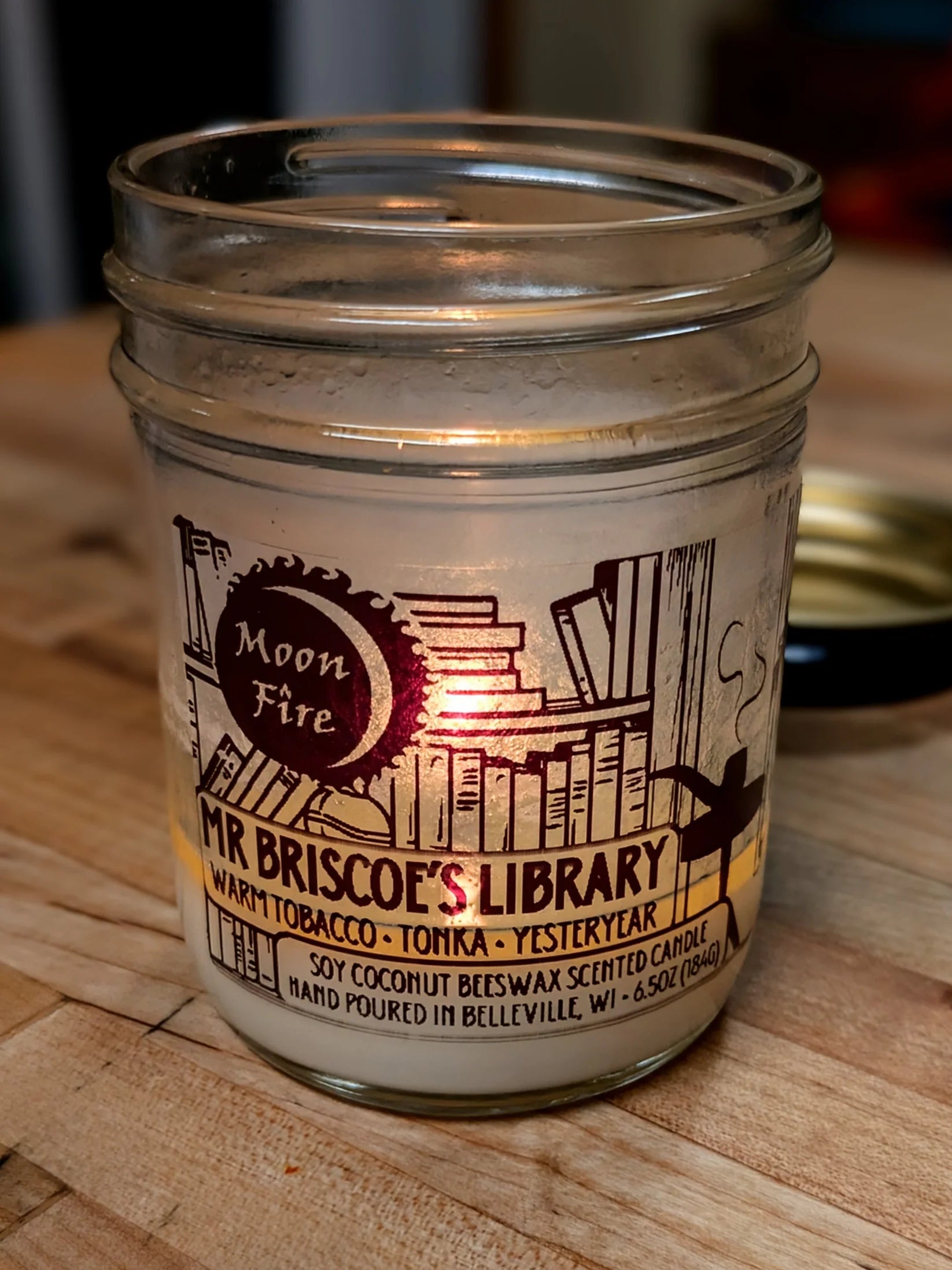 'Moonfire' brand 'Mr. Briscoe's LIbrary' scented candle with a book themed label.