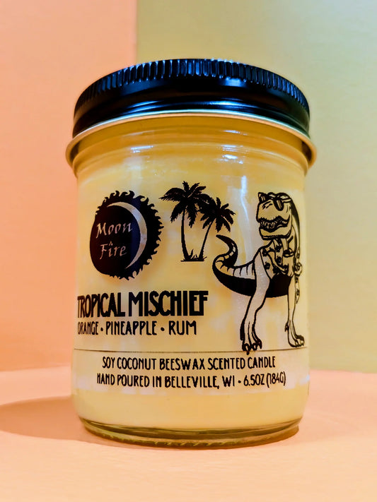 Moonfire brand 'Tropical Mischief' scented candle on a bright, colorful background.