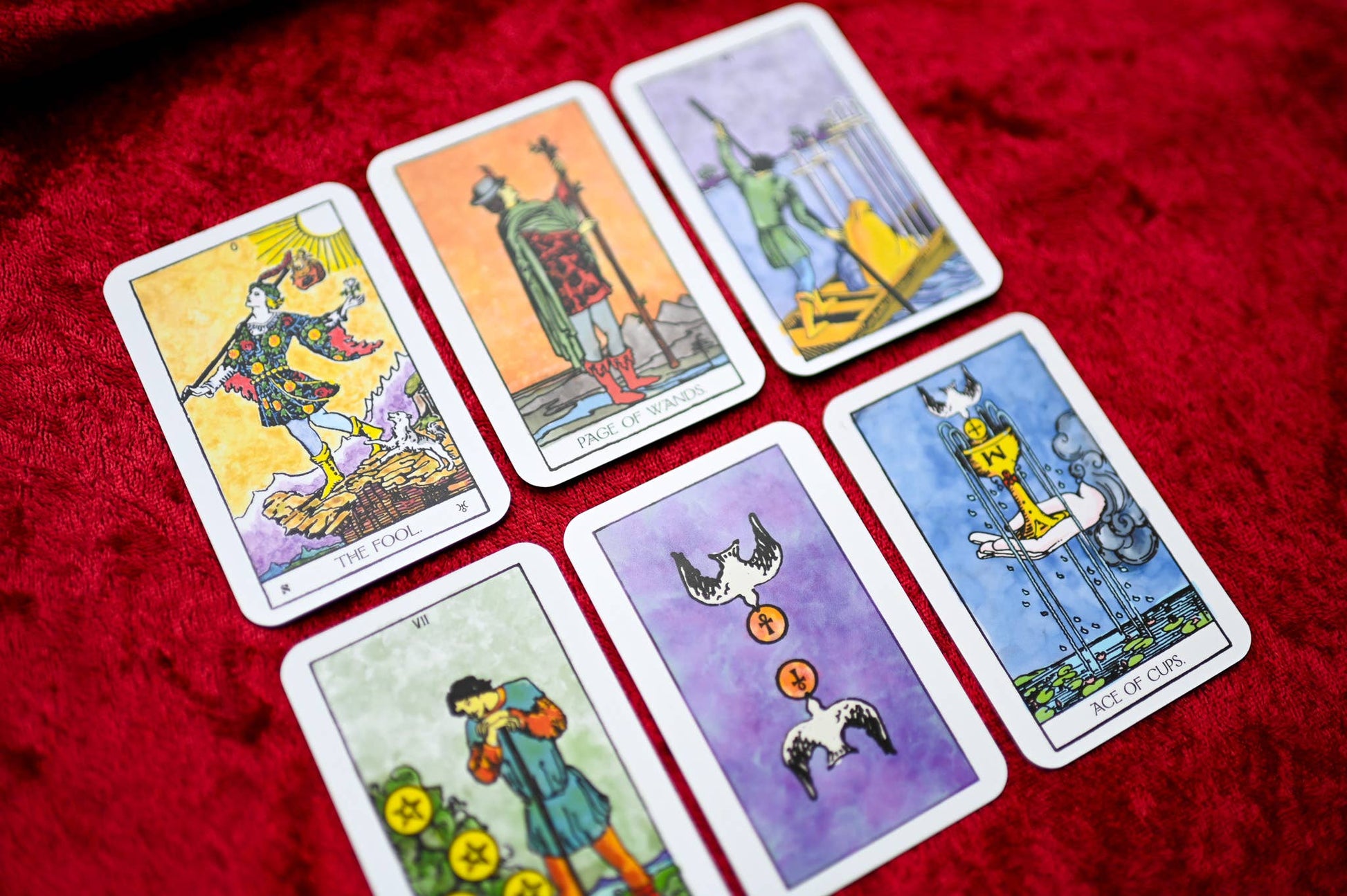 Set of tarot cards on a red fabric background