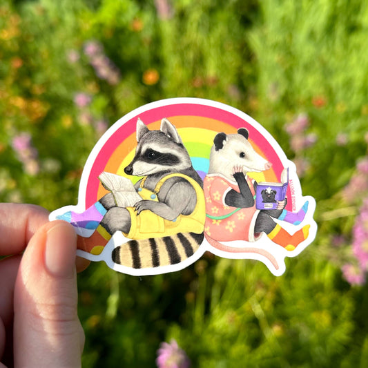 Reading Raccoon and Opossum Rainbow Pride Weatherproof Vinyl Sticker